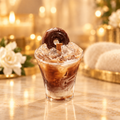 Iced coffee and donut candle with a warm golden background