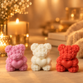 Pink, white and red rose teddy bear candles on a warm golden background