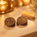 Chocolate cookie and wafer cookie candle melts on a warm golden background